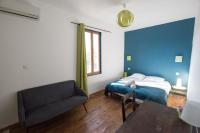 a bedroom with a bed and a chair and a table at Ateliers, Terrasse - Parking - Clim in Arles