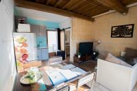 a living room with a table and a kitchen at Ateliers, Terrasse - Parking - Clim in Arles