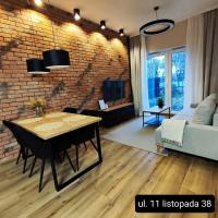 Televízia a/alebo spoločenská miestnosť v ubytovaní Asti Apartamenty Centrum Stargard