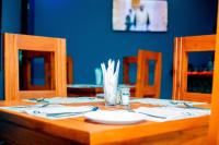 a wooden table with utensils on top of it at Kiteme Comfort Lodge in Arusha