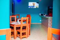 a dining room with a wooden table and chairs at Kiteme Comfort Lodge in Arusha