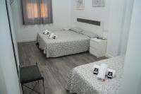 Postel nebo postele na pokoji v ubytování Hostal Goyesco Plaza