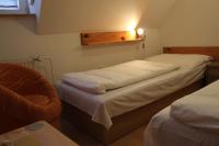 A bed or beds in a room at Penzión U Johna