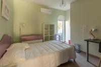 a bedroom with a bed and a table and a window at Magnifique maison avec piscine a Gujan-Mestras in Gujan-Mestras