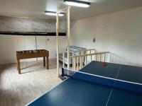 a room with a ping pong table and a bunk bed at Lovely holiday home in Gouvy with sauna in Gouvy