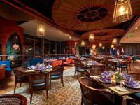 a dining room with tables and chairs and a restaurant at Luxury Seaview Panorama Nha Trang by Luna in Nha Trang