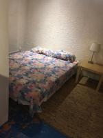 - une chambre avec un lit et une table avec une lampe dans l&#39;établissement Lovely Cevenol village house, à Saint-Laurent-le-Minier