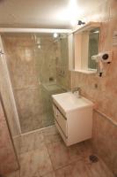 a bathroom with a shower and a sink and a mirror at Pousada Sino dos Ventos in Campos do Jordão