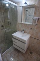 a bathroom with a sink and a shower at Pousada Sino dos Ventos in Campos do Jordão