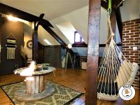 a living room with a hammock in the middle at La Caze Paloise ~ Atypique ~ 100% Fonctionnel in Pau