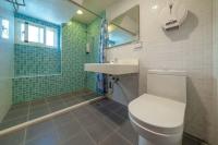 a bathroom with a toilet and a sink and a shower at Hejia B&amp;B in Hualien City