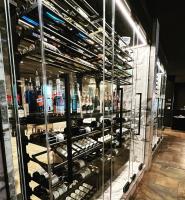 een vitrine gevuld met veel flessen alcohol bij Hotel & Suites Le Dauphin Drummondville in Drummondville