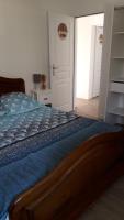 a bedroom with a bed with a blue comforter at GITE LES 3 EDELWEISS - Maison SEGUITTE - 6 PERSONNES in Arette