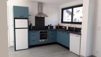 a kitchen with blue cabinets and a white refrigerator at GITE LES 3 EDELWEISS - Maison SEGUITTE - 6 PERSONNES in Arette