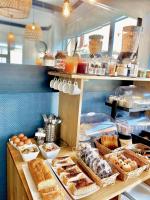 a bakery with bread and other food items on a counter at Hôtel Jules in Le Touquet-Paris-Plage