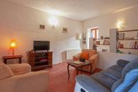 a living room with two couches and a tv at Casuccia in Santo-Pietro-di-Tenda