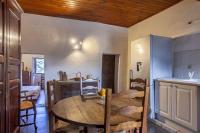 a kitchen and dining room with a wooden table at Casuccia in Santo-Pietro-di-Tenda