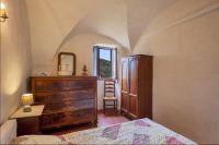 a bedroom with a bed and a dresser and a mirror at Casuccia in Santo-Pietro-di-Tenda