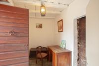 a room with a table and a wooden door at Casuccia in Santo-Pietro-di-Tenda