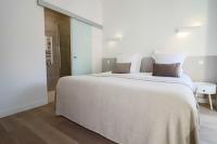 a bedroom with a large white bed with two pillows at NAPOLEON Luxurious renovated apartment 1min from Palais in Cannes