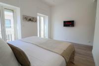 a bedroom with a bed and a tv on the wall at NAPOLEON Luxurious renovated apartment 1min from Palais in Cannes