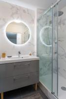 a bathroom with a sink and a shower at T2 Marvel Apartment Near DisneylandParis in Serris