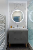 a bathroom with a sink and a mirror at T2 Marvel Apartment Near DisneylandParis in Serris