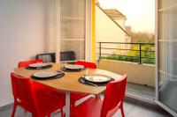 a dining room with a table and red chairs at T2 Marvel Apartment Near DisneylandParis in Serris