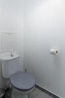 a bathroom with a white toilet and a roll of toilet paper at T2 Marvel Apartment Near DisneylandParis in Serris