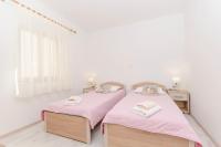 Postel nebo postele na pokoji v ubytování Apartments Silvana