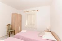 Postel nebo postele na pokoji v ubytování Apartments Silvana