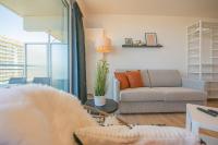 a living room with a couch and a chair at Ostend Studio in Ostend