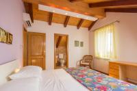a bedroom with a bed and a desk and a window at Apartment Zlendic in Gornje Selo