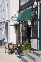 a group of chairs and tables outside of a restaurant at Pension Karina Schwerin in Schwerin