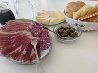 a table topped with cheese and meats and other foods at B&B e Home Restaurant S'ispera Monolocale uso esclusivo in Fonni