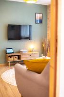 Telewizja i/lub zestaw kina domowego w obiekcie Le 05-GregIMMO-Appart'Hôtel