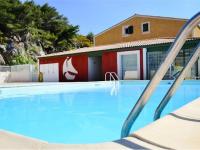 a swimming pool with a slide in front of a building at Apartment Eden Roc 2 by Interhome in Narbonne-Plage