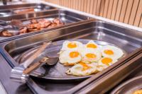 Un plato de huevos en una sartén en un buffet. en Vistamar Hotel Luxury Wellness By DLV -Adults Only-, en Villajoyosa