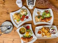 een tafel met vier borden eten erop bij Kamala Beach D68 Exclusive Junior Suite in Kamala Beach