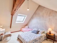 a bedroom with two beds in a attic at Holiday Home Les Roses by Interhome in Yffiniac