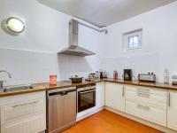 a kitchen with white cabinets and a stove top oven at Apartment la Rainette by Interhome in La Madrague