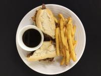 a sandwich and french fries on a plate with a cup of coffee at Lake Louise Inn in Lake Louise