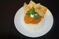 a plate of food with rice and meat and chips at Lake Louise Inn in Lake Louise