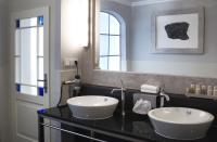 a bathroom with two white sinks and a mirror at Boutique Hotel Nautilus in Tábor