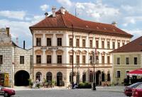 a large white building with a red roof at Boutique Hotel Nautilus in Tábor