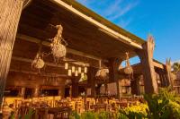 a restaurant with tables and chairs in a building at Hotel Isla Mucura in Isla Mucura