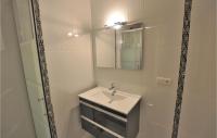 a white bathroom with a sink and a mirror at Nice Apartment In Cannes With Wifi in Cannes