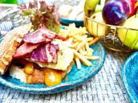 un plato de comida con un sándwich y papas fritas en Imperial Resort Hurghada, en Hurghada