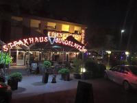 a building with a sign that is lit up at night at Hotel Friesengeist in Wiesmoor