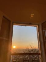 a window with a view of the sunset at Le Clos des Grands Frênes in Pons